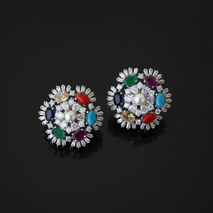 Pair of colorful gemstone earrings on a dark background