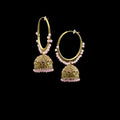 Gold hoop earrings with pink beads on a black stand against a gray background