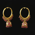 Gold hoop earrings with red gemstones on a black background, branded 'Saheli'.