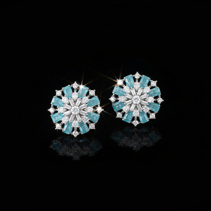 Pair of earrings with turquoise stones on a dark background
