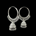 Silver hoop earrings with dangling elements on a gray background, featuring the brand 'SAHELI'.