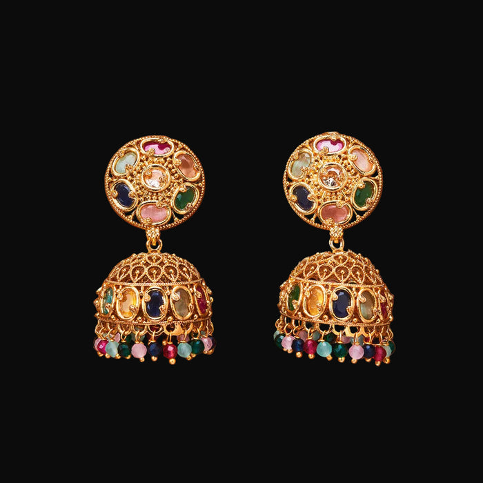 Pair of gold earrings with colorful gemstones on a brown background