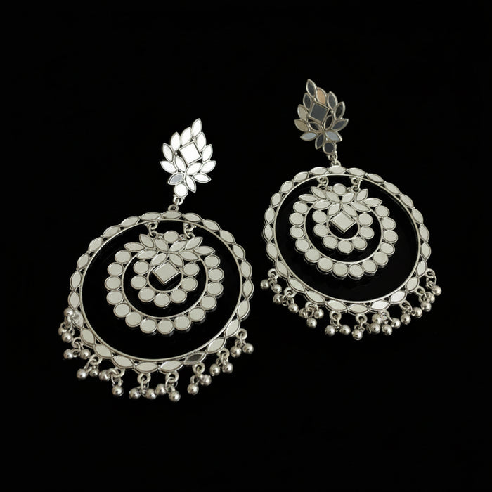 Pair of silver earrings on a black background