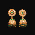 Gold and green floral earrings on a brown background