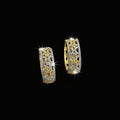 Gold hoop earrings with intricate designs on a dark background, featuring the brand 'Saheili'.