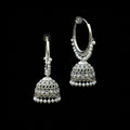 Silver hoop earrings with Jhumka designs on a black background