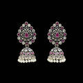 Pair of silver and pink earrings on a gray stand with 'Saheli' branding.