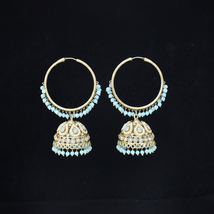 Pair of gold hoop earrings with turquoise stones on a black background