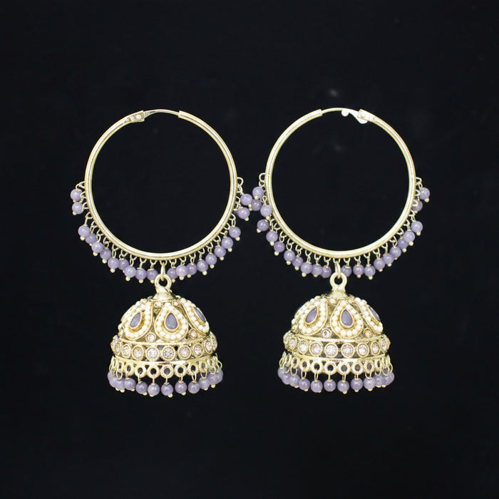 Gold hoop earrings with jhumka designs on a black background