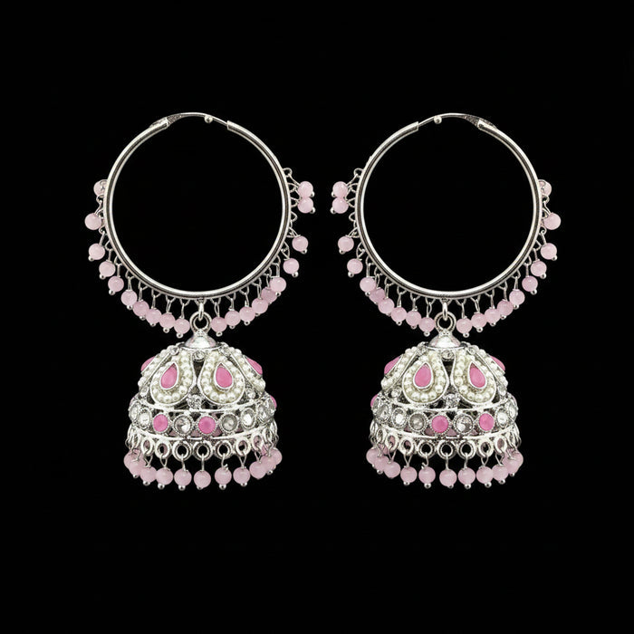 Pair of silver hoop earrings with pink beads on a gray stand.