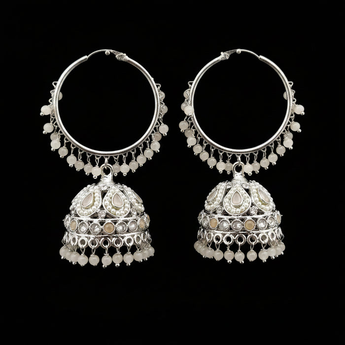 Pair of silver hoop earrings with intricate designs on a gray background
