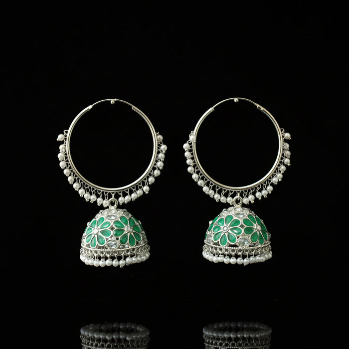 Pair of silver hoop earrings with green floral designs on a black background