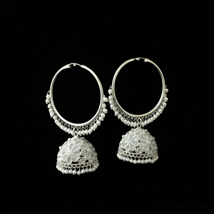 Pair of silver hoop earrings with floral designs on a black background
