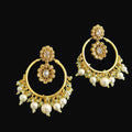 Gold earrings with pearl accents on a dark background