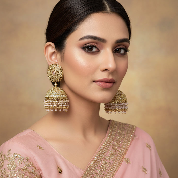 Gold and pearl earrings on a gray background with HP logo.
