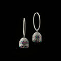 Silver earrings with gemstones on a black stand with HP logo in the background