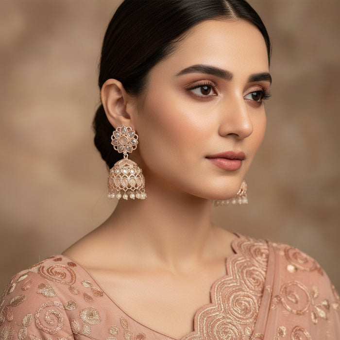 Pair of silver jhumka earrings on a black background