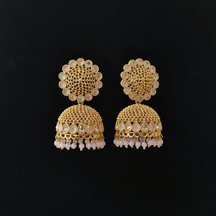 Gold earrings with intricate design on a black background