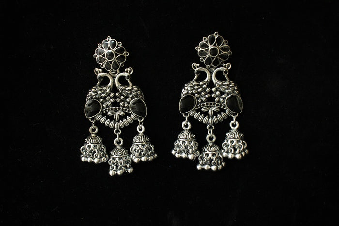 Pair of silver earrings on a black background