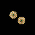 Gold floral earrings with green gemstones on a gray background, featuring the 'SAHELI' brand.
