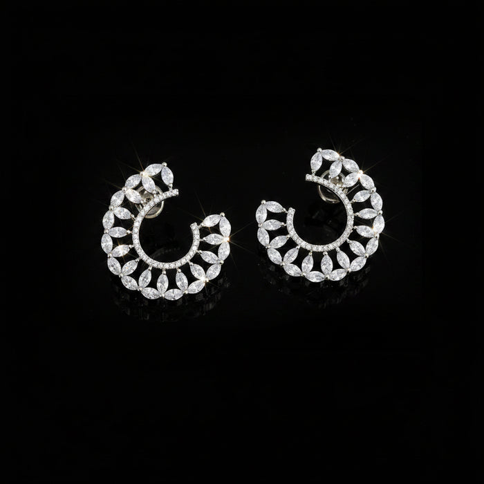 A pair of silver crescent-shaped hoop earrings adorned with clear marquise-cut crystals, displayed on a dark reflective surface with the SAHELL MY BEST FRIEND logo above them. Clear gemstones do not contribute to the color mapping, so the primary product color is Silver.