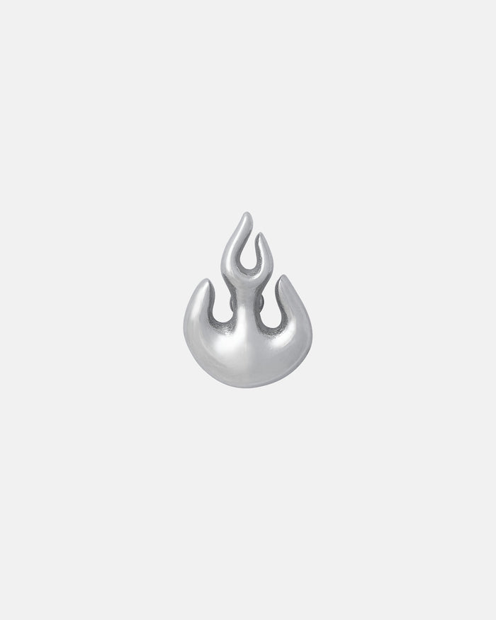 The Flame Stud Earring is a small, silver, abstract flame-shaped stud with smooth, rounded edges. Crafted from hypoallergenic stainless steel, it's displayed on a plain light gray background.