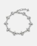 The "Fleur De Lis" 15mm Bracelet by Statement Collective showcases a silver design with alternating fleur-de-lis and pointed spike charms, finished with a lobster clasp and a small dangling fleur-de-lis charm at the end.