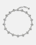 The "Fleur De Lis" 15mm Chain by Statement Collective features linked fleur-de-lis charms evenly spaced along a silver chain, with an adjustable clasp and a dangling charm at the end, displayed on a plain white background.