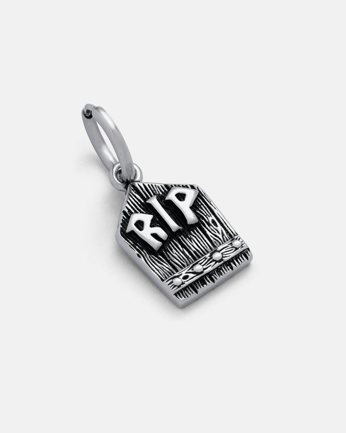 The Gravestone Earring features a silver tombstone design with raised RIP letters and engraved details, symbolizing rest in peace. Witchy and unique, it has a loop at the top to easily add to your favorite earring hooks.