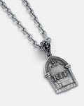 The Gravestone Pendant is a silver chain necklace with a tombstone-shaped pendant featuring "RIP," angel wings, and a small skull—perfect for fans of grim jewelry.