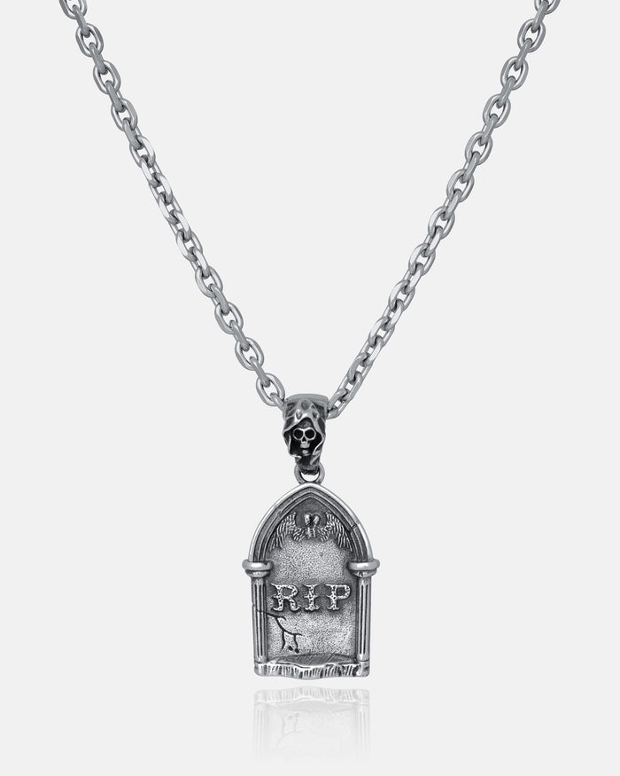 The Gravestone Pendant is a silver necklace with a tombstone charm engraved with RIP and topped by a small skull—ideal for those who love dark, gothic-inspired jewelry.