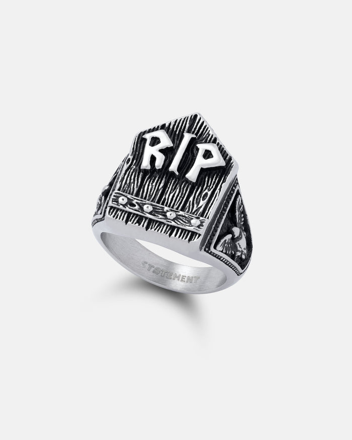 The Gravestone Ring is a silver macabre jewelry piece shaped like a tombstone with raised RIP letters on the front, engraved details, and a small skull design on the side.