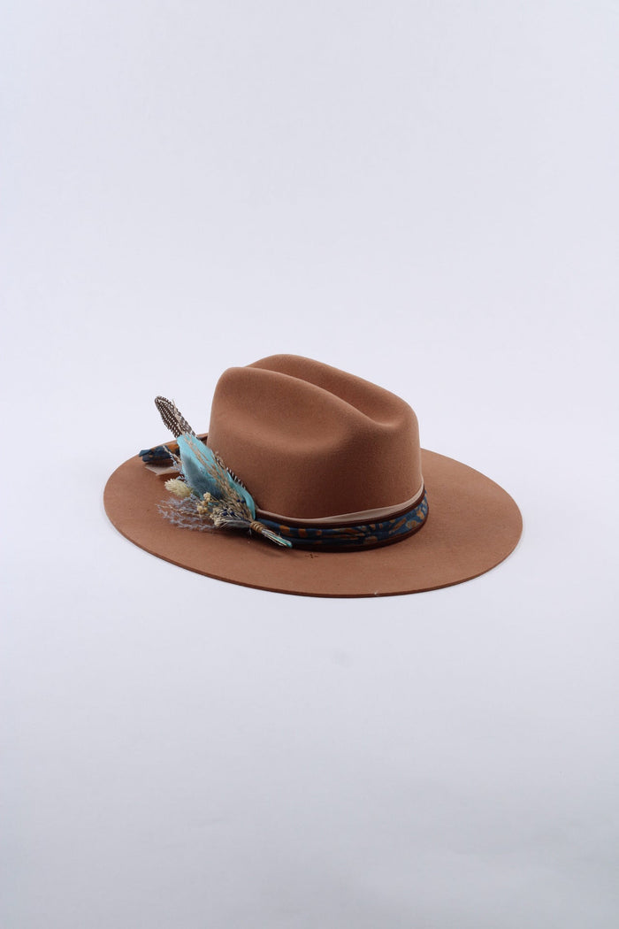 Close view of the hand-burned sunset and mountain design on the wool hat