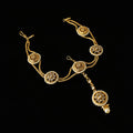 Gold necklace with decorative elements on a dark background