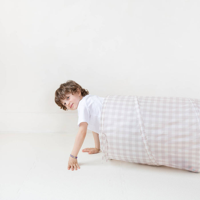 Child playing in white terrazzo tunnel