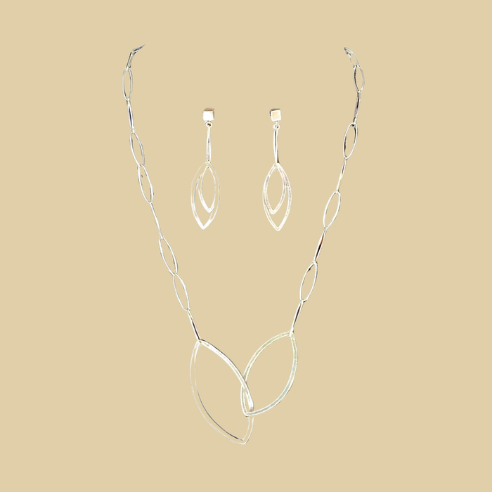 Leaf pendant necklace in sterling silver by Grace Chin, shown on a bone linen background