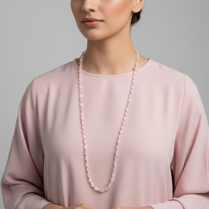 Necklace with pink beads on a dark gray background