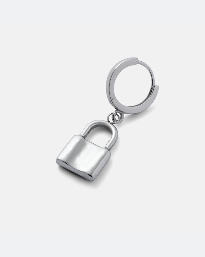 The Mini Padlock Earring is a sleek silver padlock charm suspended from a classic hoop, shown against a plain light gray background—an ideal men’s accessory with modern style.