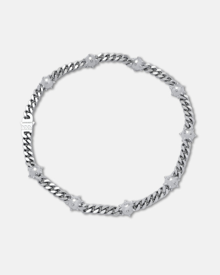 The "Morning Star" Cuban Chain necklace in silver features white flower-shaped accents and is displayed against a plain light gray background.