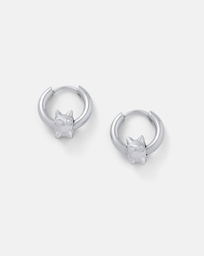 A pair of "Morning Star" silver waterproof hoop earrings, each adorned with a small cat head charm with pointed ears, displayed on a plain white background.