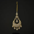 Gold decorative hairpin with intricate designs on a black background