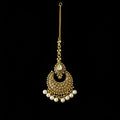 Gold necklace with pearl accents on a dark background, featuring the brand 'Saheli'.