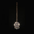 Jewelry pendant with intricate design on a dark background