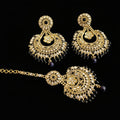 Ornate gold and black jewelry set with 'SAHELI' branding on a gray background