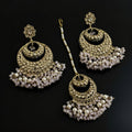 Set of gold and pearl earrings on a dark background