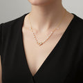 Pearl necklace with a gold clasp on a black background