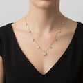 Gold necklace with diamond pendants on a black background