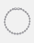 The No Tourists Choker is a silver beaded necklace with round, polished metal beads in a ball chain style and a rectangular STATEMENT-engraved clasp, shown on a plain white background.
