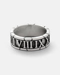 Discover the Numerals Ring by Statement Collective—a striking silver band adorned with engraved Roman numerals from VII to XII. Its slightly oxidized background highlights the polished rim, making it an ideal choice for stacking or wearing as a standout statement piece.