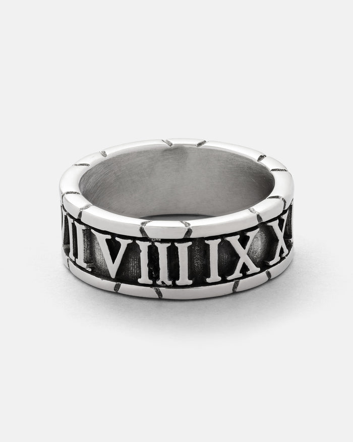 Discover the Numerals Ring by Statement Collective—a striking silver band adorned with engraved Roman numerals from VII to XII. Its slightly oxidized background highlights the polished rim, making it an ideal choice for stacking or wearing as a standout statement piece.